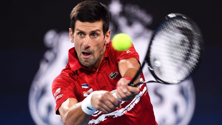 Novak Djokovic returns a ball during his match against Rafa Nadal in the 2020 ATP Cup final between Spain and Serbia.