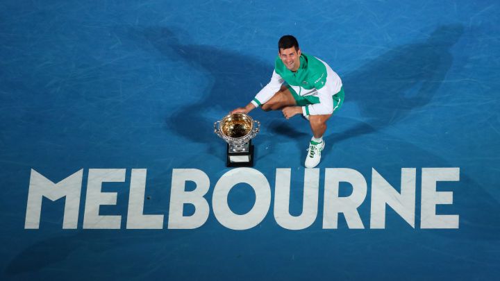 Novak Djokovic poses with the 2021 Australian Open champion trophy after defeating Daniil Medvedev in the final.
