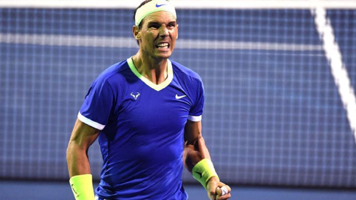 Rafa Nadal clenches a fist when celebrating a point.