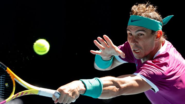 Spain's Rafael Nadal hits a return against Marcos Giron of the US during their men's singles match on day one of the Australian Open tennis tournament in Melbourne on January 17, 2022. (Photo by Brandon MALONE / AFP) / -- IMAGE RESTRICTED TO EDITORIAL USE - STRICTLY NO COMMERCIAL USE --
