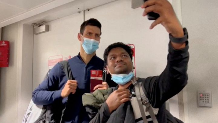 Serbian tennis player Novak Djokovic poses for a selfie after landing at Dubai Airport after the Australian Federal Court upheld a government decision to cancel his visa to play in the Australian Open, in Dubai, United Arab Emirates, January 17, 2022, in this still image taken from video. REUTERS/Loren Elliott     TPX IMAGES OF THE DAY