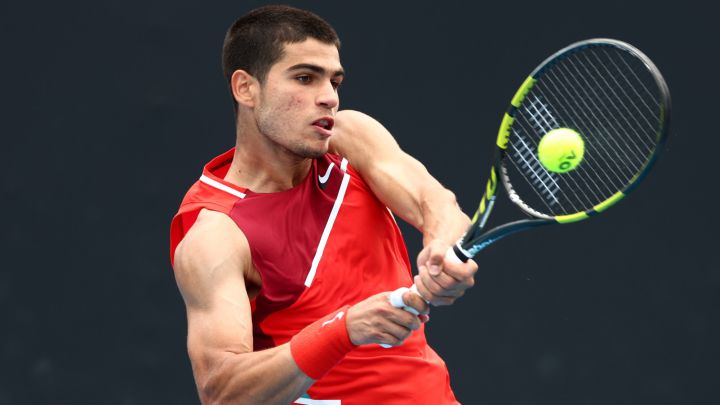 MELBOURNE, AUSTRALIA - JANUARY 17: Carlos Alcaraz of Spain plays a backhand in his first round singles match against Alejandro Tabilo of Chile during day one of the 2022 Australian Open at Melbourne Park on January 17, 2022 in Melbourne, Australia.  (Photo by Clive Brunskill/Getty Images)