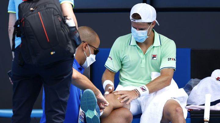 MELBOURNE, AUSTRALIA - JANUARY 18: Diego Schwartzman of Argentina receives attention during a medical time out in his first round singles match against Filip Krajinovic of Serbia during day two of the 2022 Australian Open at Melbourne Park on January 18, 2022 in Melbourne, Australia. (Photo by Daniel Pockett/Getty Images)