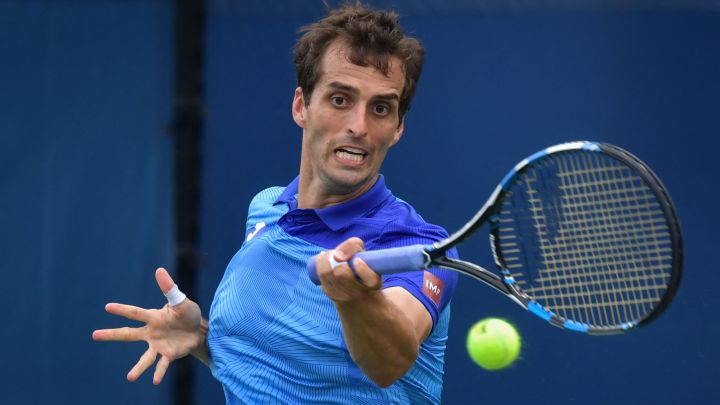 Spanish tennis player Albert Ramos returns a ball during his match against Frenchman Lucas Pouille at the US Open 2021.