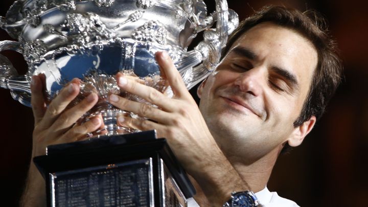 Swiss tennis player Roger Federer poses with the 2018 Australian Open champion trophy.