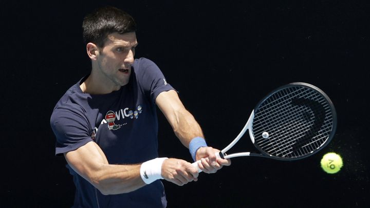 Serbian tennis player Novak Djokovic returns a ball during a training session prior to the Australian Open 2022, where he was finally unable to play after being deported from Australia.