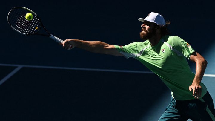 American tennis player Reilly Opelka returns a ball during his match against Denis Shapovalov at the 2022 Australian Open.