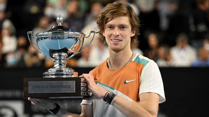 Andrey Rublev of Russia poses with the trophy after winning the final tennis match against Felix Auger-Aliassime of Canada (unseen) at the ATP Open 13 in Marseille, on February 20, 2022. (Photo by Nicolas TUCAT / AFP)