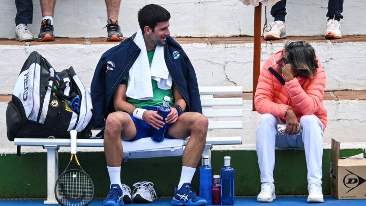Serbian tennis player Novak Djokovic talks to his assistant Pepe Imaz during a training session at Puente Romano Tennis Club in Marbella, Spain, January 3, 2022. Picture taken January 3, 2022. KMJ-GTRES/Handout via REUTERS THIS IMAGE HAS BEEN SUPPLIED BY A THIRD PARTY.