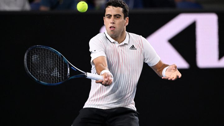 Spanish tennis player Jaume Munar returns a ball during his match against Aslan Karatsev at the Australian Open 2022.