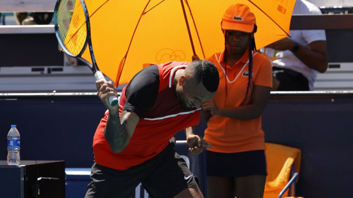 Mar 29, 2022;  Miami Gardens, FL, USA;  Nick Kyrgios (AUS) smashes his racquet at the end of the first set after being assessed a point penalty against Jannik Sinner (ITA)(not pictured) in a fourth round men's singles match in the Miami Open at Hard Rock Stadium.  Mandatory Credit: Geoff Burke-USA TODAY Sports