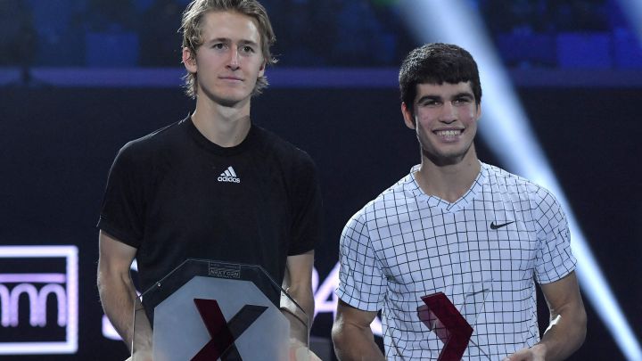 Spain's Carlos Alcaraz (R) celebrates with the winner's trophy next to runner up, USA's Sebastian Korda at the end of their final tennis match at the Next Generation ATP Finals on November 13, 2021 at the Allianz Cloud venue in Milan.  (Photo by Tiziana FABI / AFP)