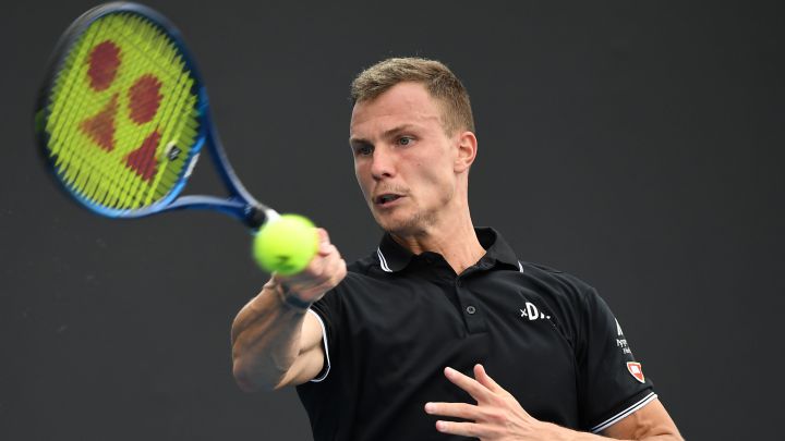 Hungarian tennis player Marton Fucsovics returns the ball during a match.