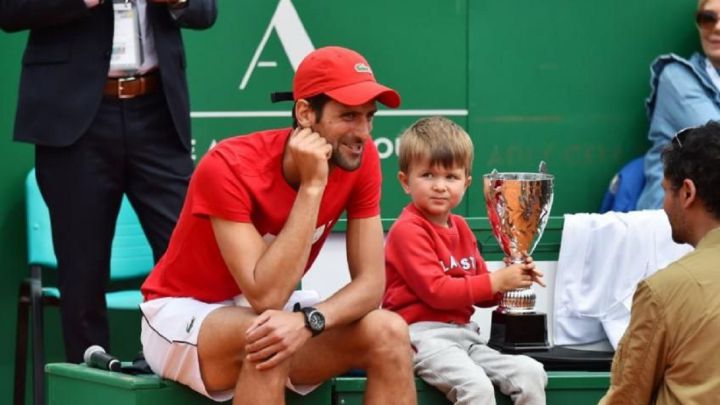 Serbian tennis player Novak Djokovic poses with his son Stefan after a tournament.