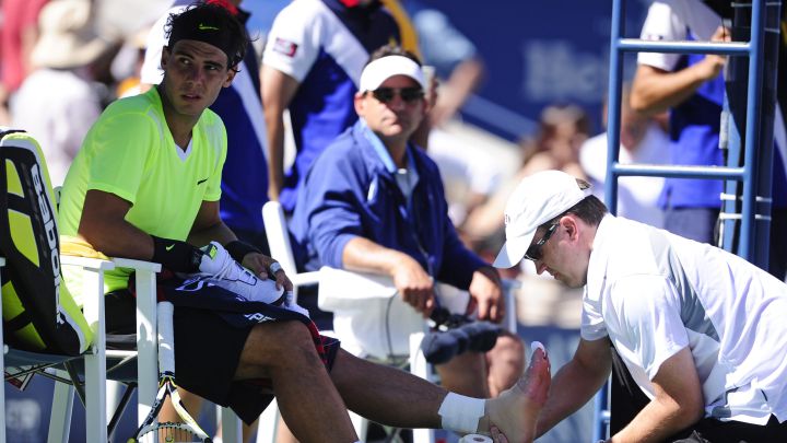 Spanish tennis player Rafa Nadal receives treatment on his left foot during his match against Mikhail Youzhny at the 2010 US Open.