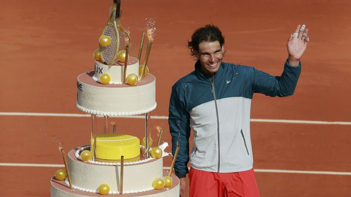 Spanish tennis player Rafa Nadal poses next to a birthday cake at Roland Garros after beating Kei Nishikori in the 2013 edition.