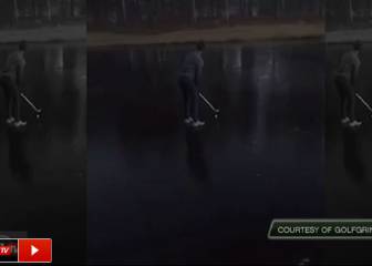 Golfer tries, and fails, with icy lake shot