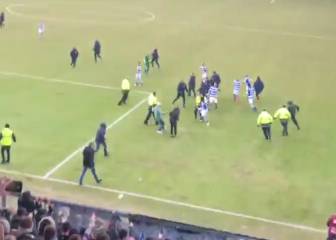 Fans storm the pitch to attack celebrating rival players